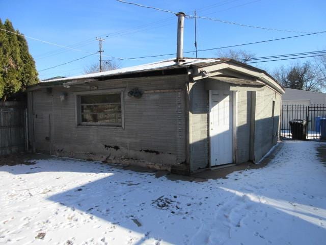 snow covered house with a garage