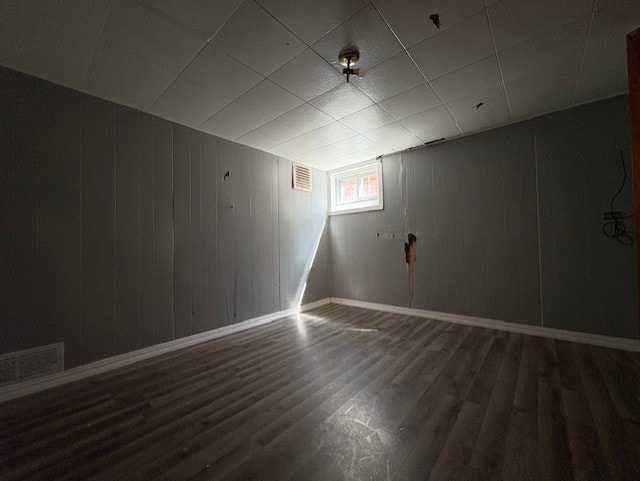 10809 S Mackinaw Ave, Chicago, IL 60617 - below grade area with visible vents, baseboards, and wood finished floors