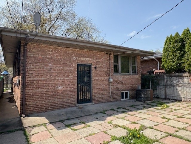 10809 S Mackinaw Ave, Chicago, IL 60617 - back of property with fence, a patio, and brick siding