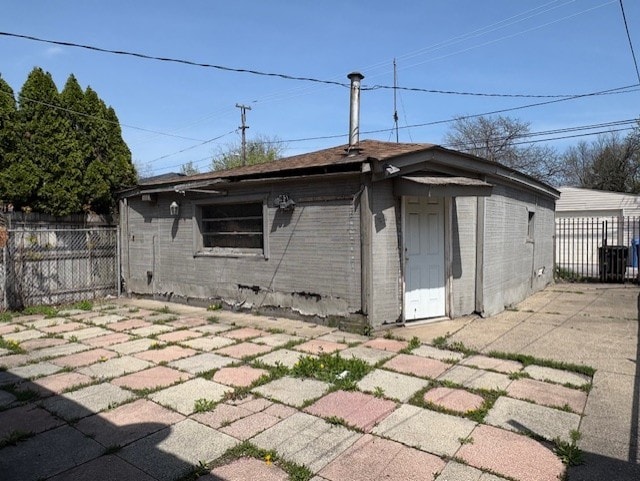 10809 S Mackinaw Ave, Chicago, IL 60617 - back of property with fence, a patio area, and brick siding