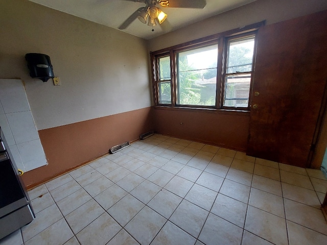 interior space with ceiling fan and light tile patterned floors