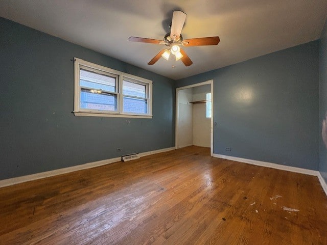 10809 S Mackinaw Ave, Chicago, IL 60617 - unfurnished bedroom with visible vents, baseboards, wood finished floors, and a closet