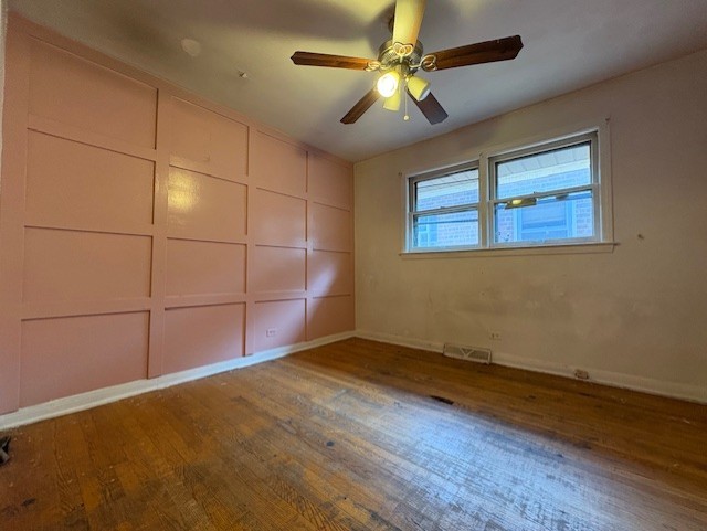 10809 S Mackinaw Ave, Chicago, IL 60617 - unfurnished room featuring baseboards, a ceiling fan, wood finished floors, and visible vents