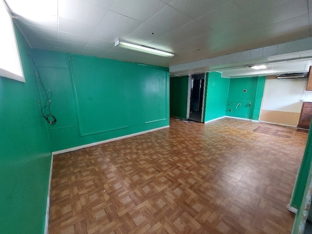 basement featuring parquet flooring