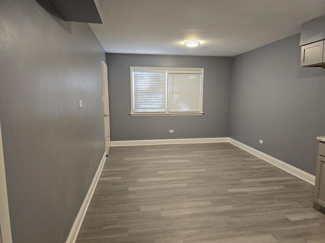 unfurnished room featuring light wood-type flooring and baseboards