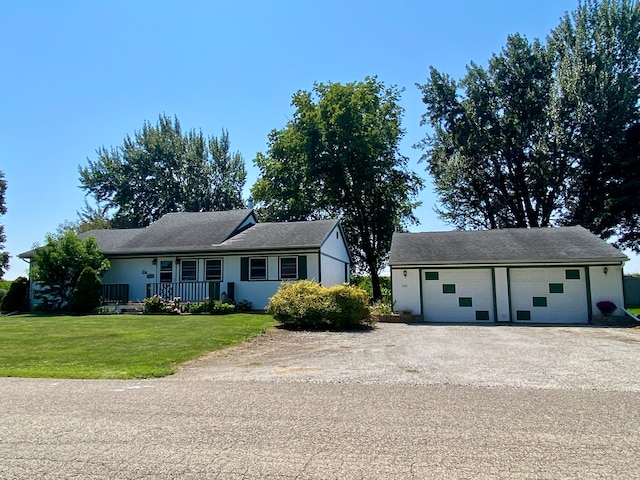 ranch-style house featuring a front yard and a garage