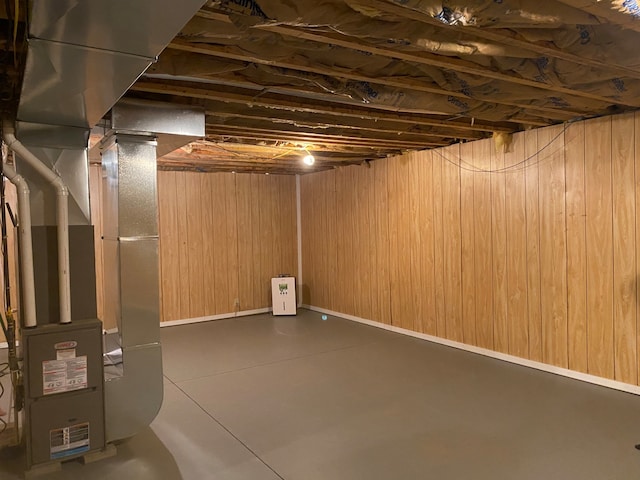 basement with wooden walls and heating unit