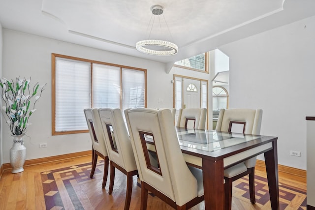 dining space featuring a notable chandelier and light hardwood / wood-style floors