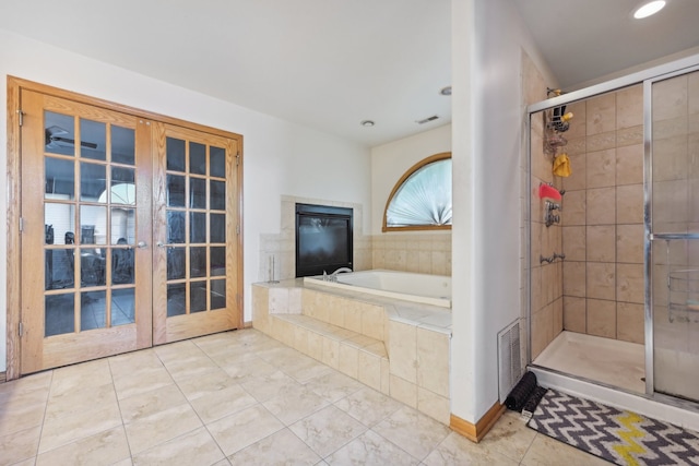 bathroom featuring plus walk in shower, tile patterned flooring, and french doors