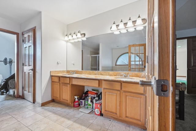 bathroom featuring a shower with shower door, tile patterned flooring, and vanity