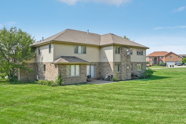 rear view of property with a yard and a patio