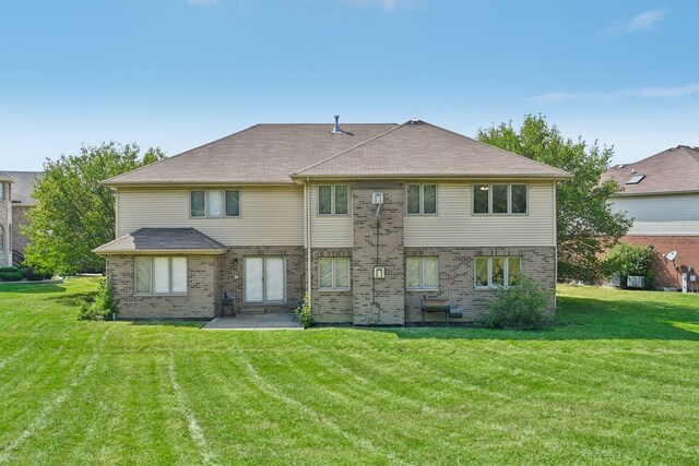 back of house featuring a patio area and a yard