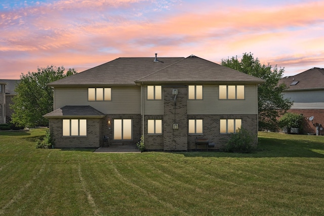 view of front of property with a lawn and a patio area