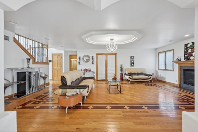 living room with hardwood / wood-style flooring and a fireplace