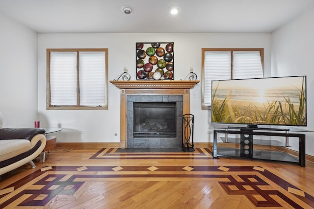 living room with hardwood / wood-style floors, a wealth of natural light, and a fireplace