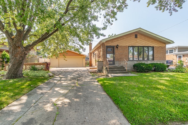 view of front of home with an outbuilding, a front yard, and a garage