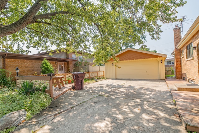 view of front of property featuring a garage and an outdoor structure