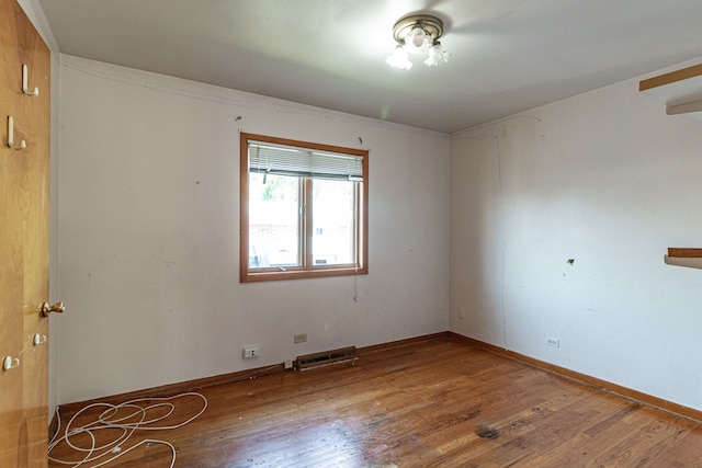 empty room with hardwood / wood-style flooring