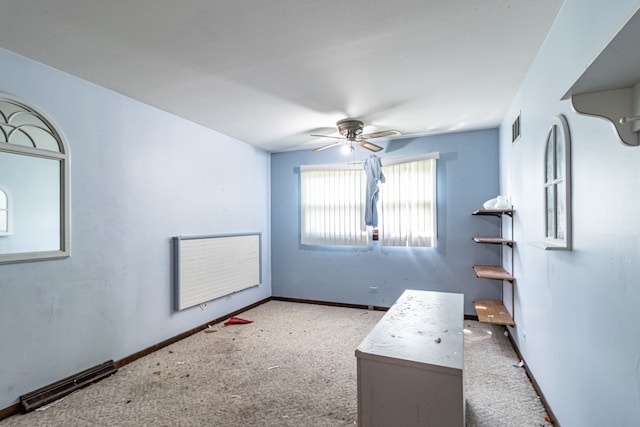 interior space featuring ceiling fan and carpet floors