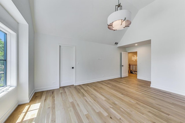 172 E Crescent Ave, Elmhurst, IL 60126 - unfurnished room featuring light wood finished floors, high vaulted ceiling, baseboards, and a chandelier