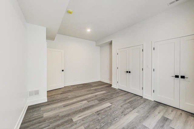 172 E Crescent Ave, Elmhurst, IL 60126 - unfurnished bedroom featuring multiple closets, wood finished floors, baseboards, and recessed lighting