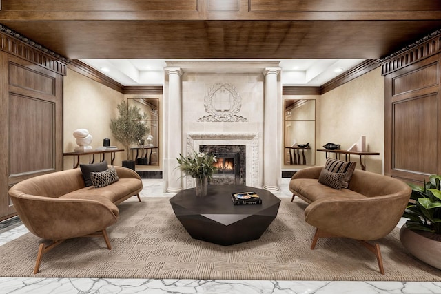 living area with decorative columns, recessed lighting, a high end fireplace, and ornamental molding