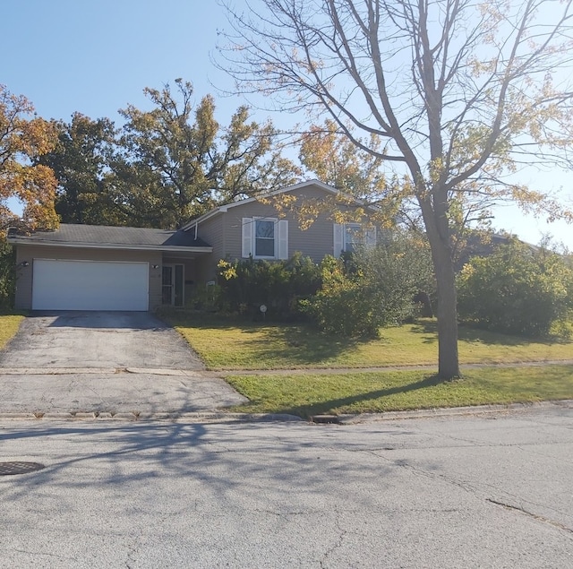 view of front facade with a front yard and a garage