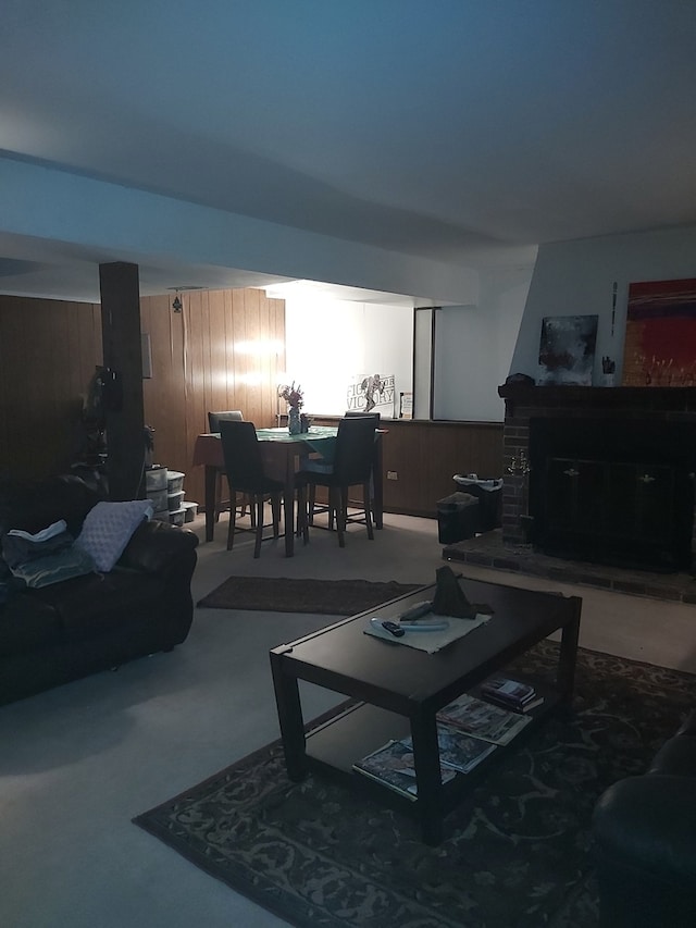 living room featuring carpet and wood walls