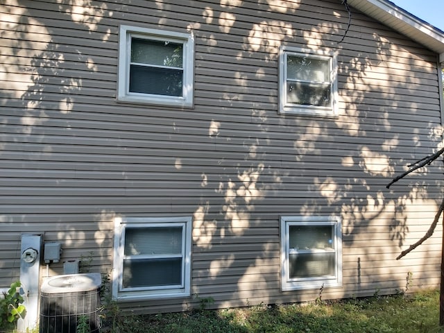 view of side of property with central air condition unit