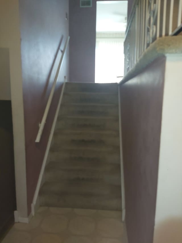 staircase featuring wood-type flooring