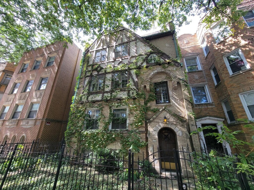 6124 N Washtenaw Ave, Chicago, IL 60659 - tudor-style house featuring a fenced front yard and brick siding