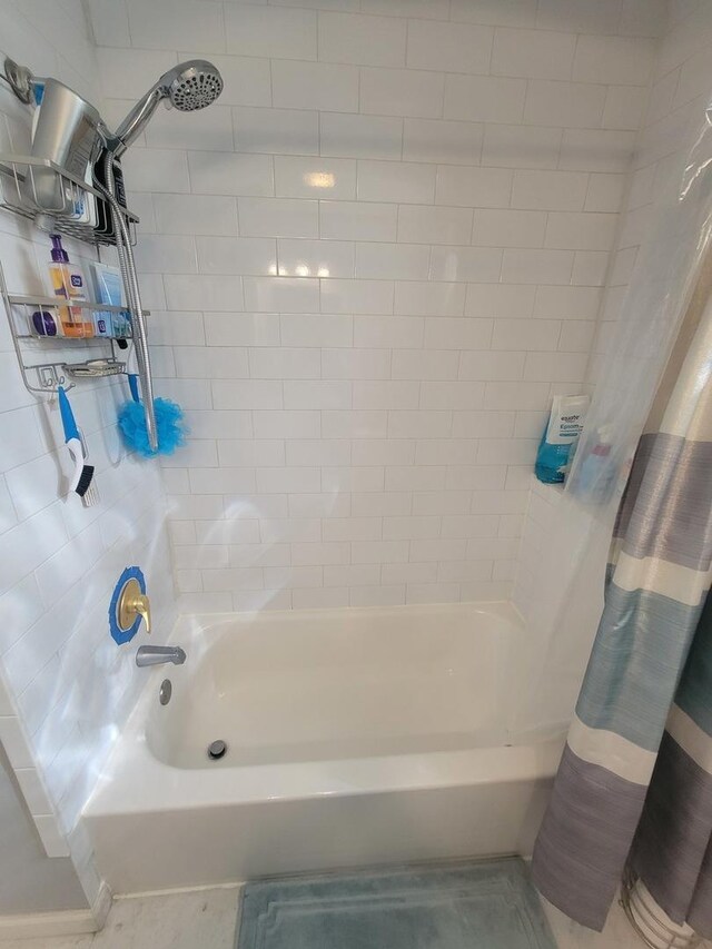 bathroom with shower / bathtub combination with curtain