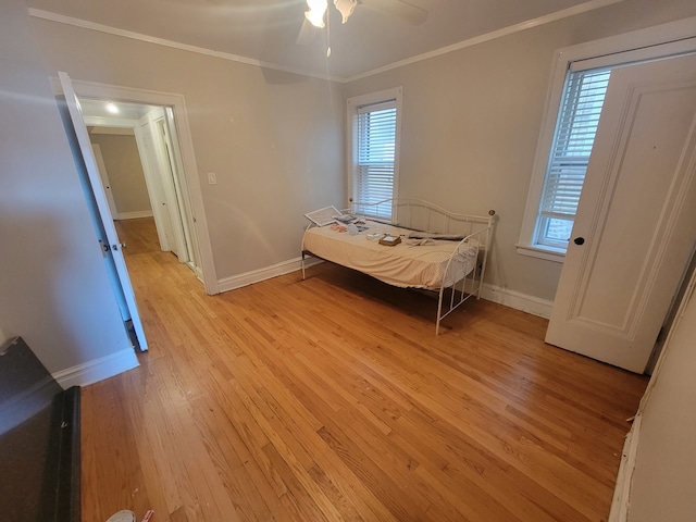 unfurnished bedroom with light wood-type flooring, ornamental molding, and ceiling fan