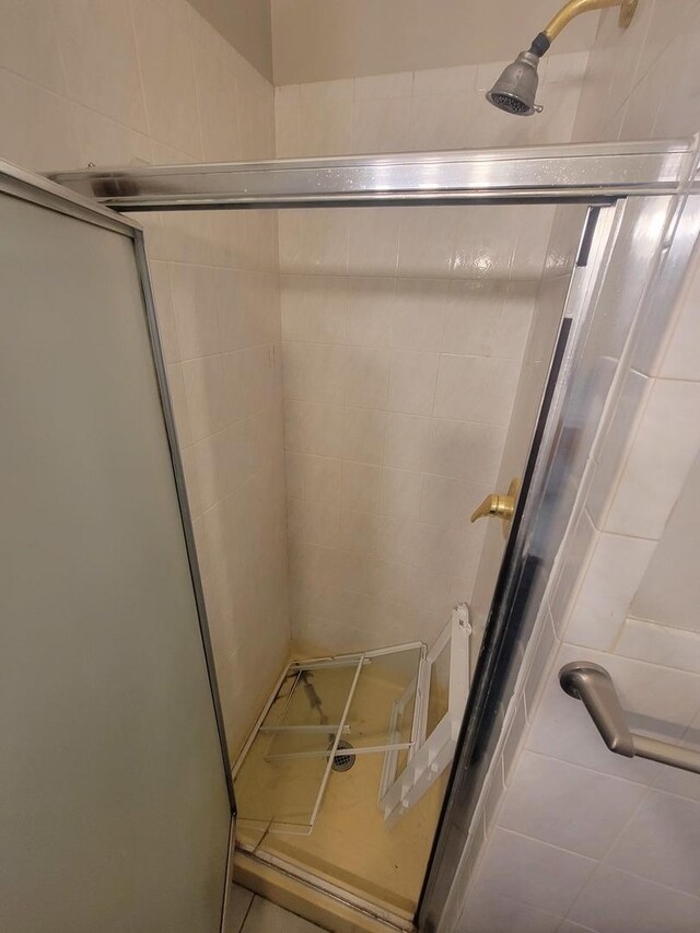 bathroom with a shower with shower door