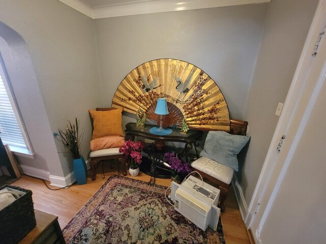 sitting room featuring hardwood / wood-style flooring and crown molding