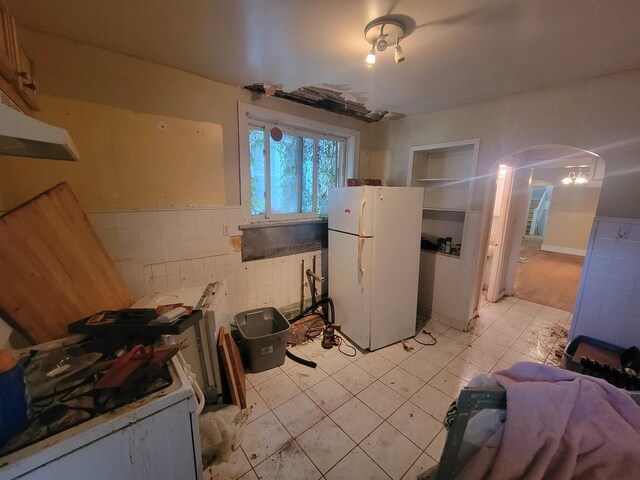 kitchen with white refrigerator and light tile patterned floors