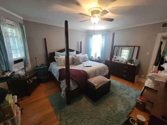 bedroom featuring ceiling fan, ornamental molding, and light wood-type flooring