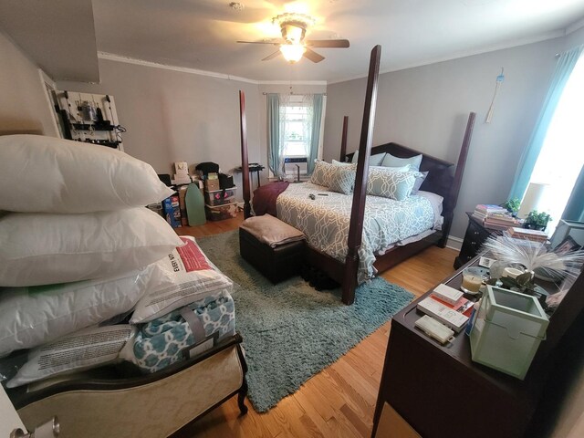 bedroom with crown molding, ceiling fan, and hardwood / wood-style flooring