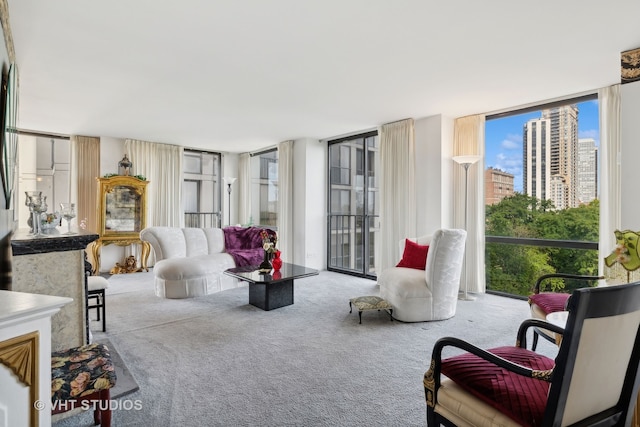 carpeted living room featuring floor to ceiling windows