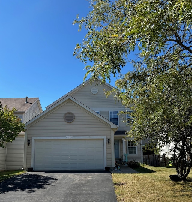 front facade with a garage and a front yard