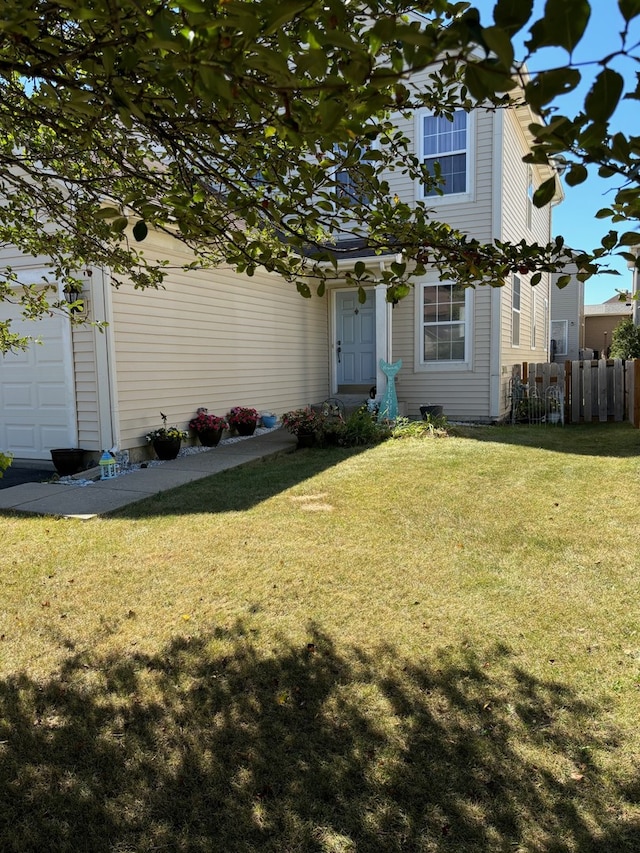 view of front facade with a garage and a front yard