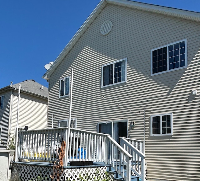 rear view of property featuring a deck