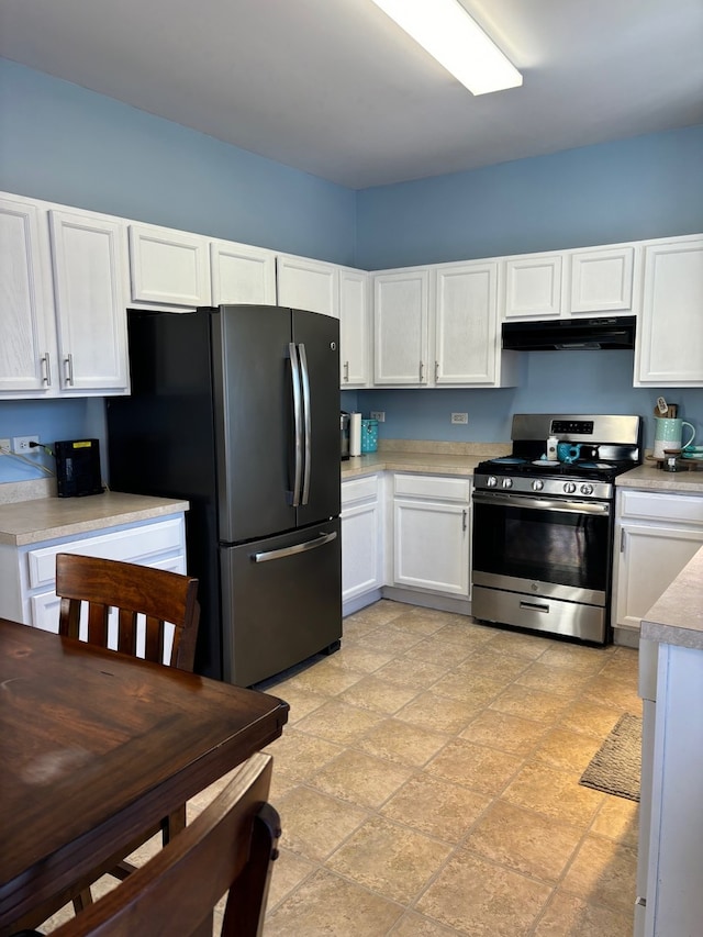 kitchen featuring extractor fan, stainless steel appliances, and white cabinets