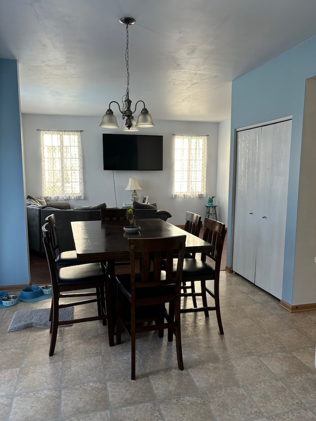 dining space featuring plenty of natural light and a chandelier