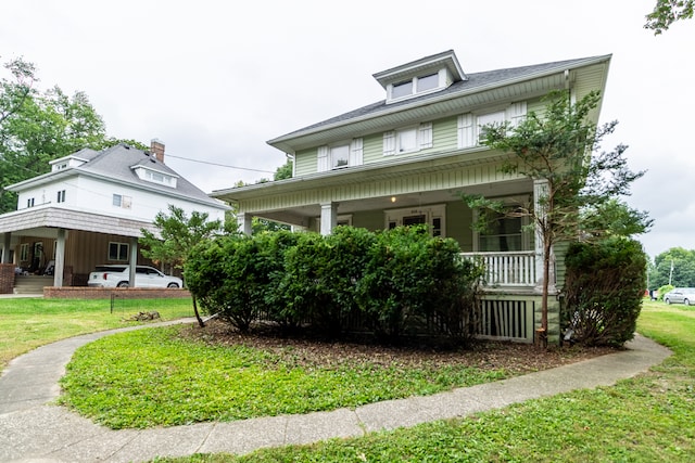 view of front facade with a porch and a front lawn