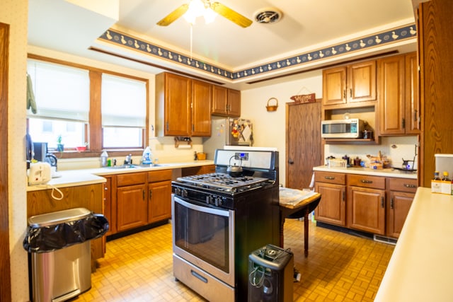 kitchen with ceiling fan, sink, and appliances with stainless steel finishes