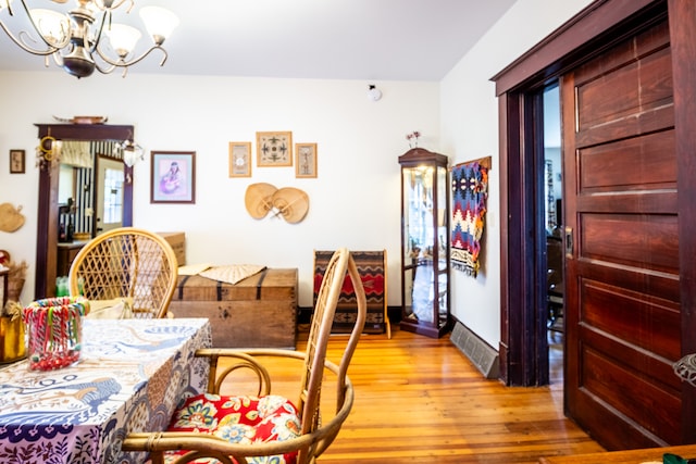 dining room with light hardwood / wood-style flooring and a notable chandelier