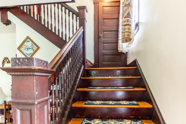 stairs with hardwood / wood-style floors