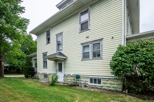 rear view of property with a lawn