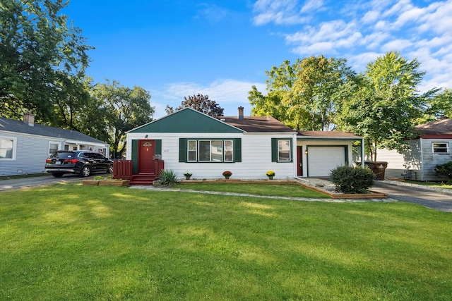 single story home featuring a garage and a front yard